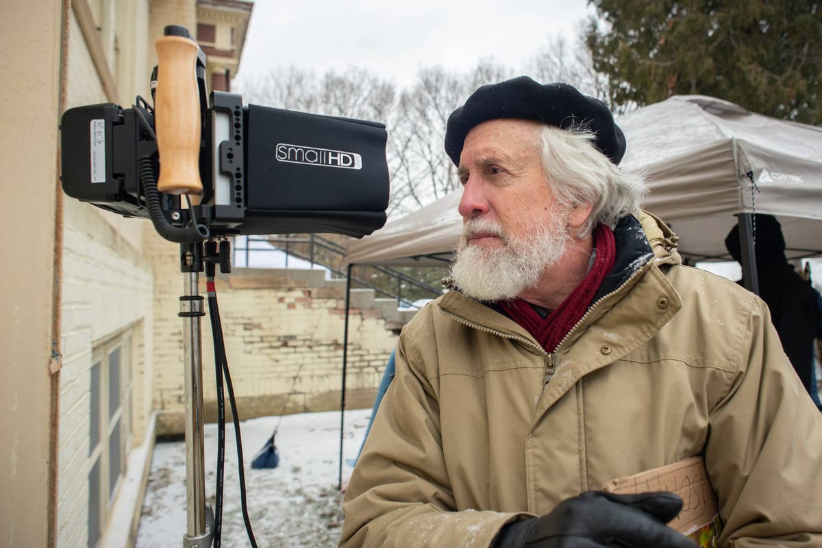 A film camera rig on set in the snow.